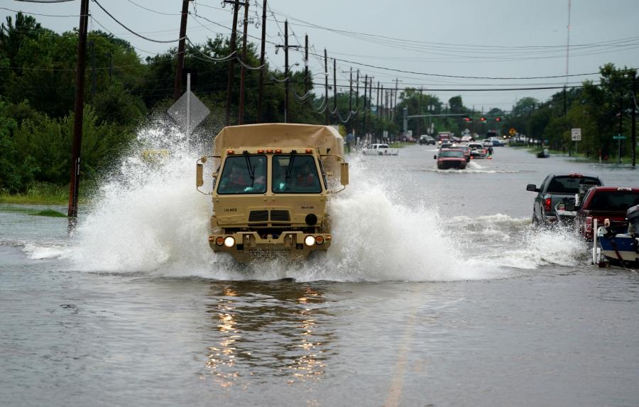 People are evacuated by a high water truck from the Hurricane Harvey floodwaters in Dickinson, Texas.