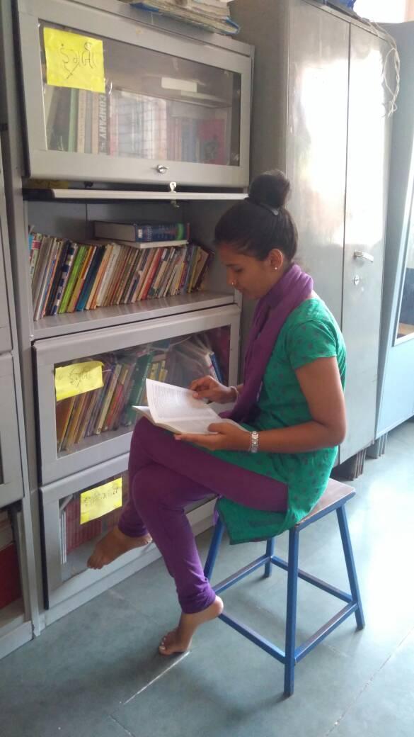 A young girl reads at a shelter for women who have survived sex trafficking. 