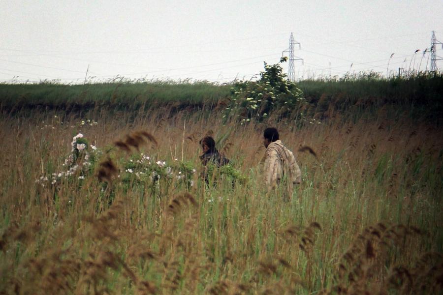 Migrants walk through a field near the Serbian-Hungarian border.