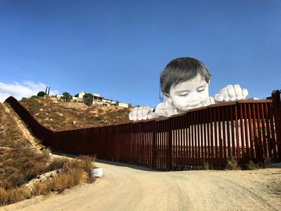 Long stretch of wall with large image of baby look over top