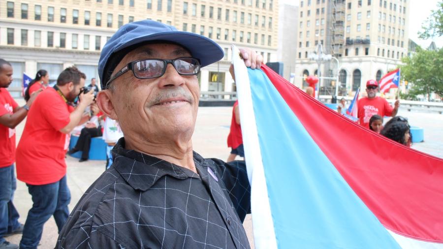 Man holding a Puerto Rican flag