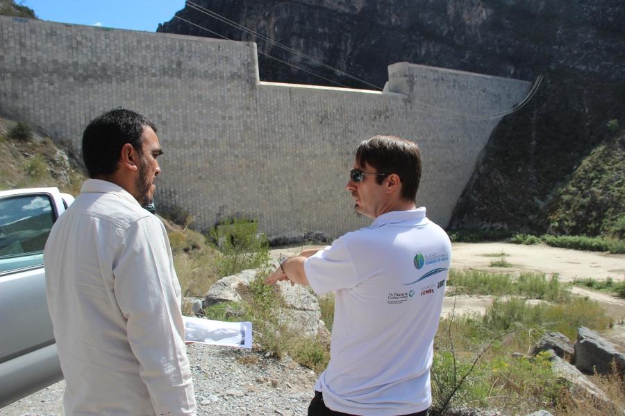 The Nature Conservancy’s Colin Herron, right, at the Rompepicos Dam. Water rose to near the top of the dam during Hurricane Alex.