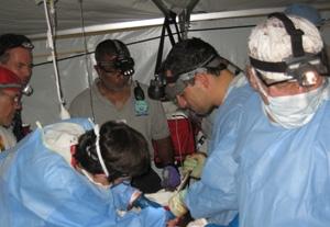 Dr. Ara Feinstein (right) performing trauma surgery on a gunshot wound victim.