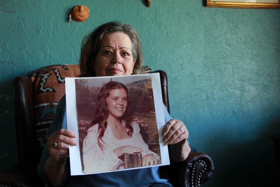 a woman holds up a picture