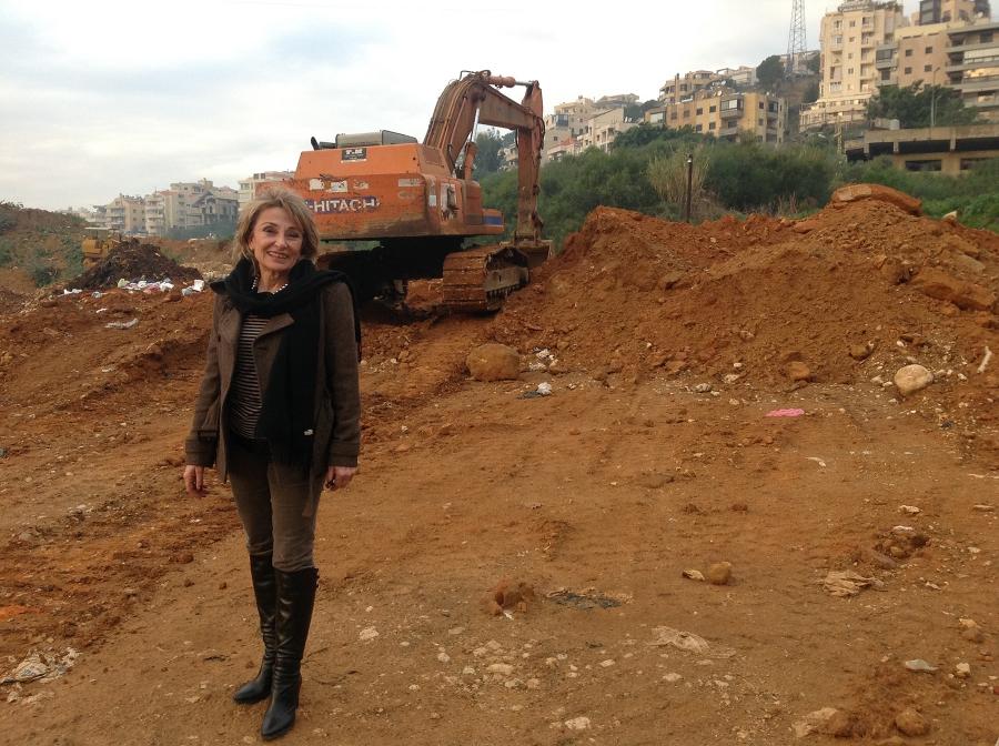 Shadia Khater, who took the lead on developing her community's recycling center, stands on a site that she hopes will become a compost facility for household foodwaste and other organic trash.