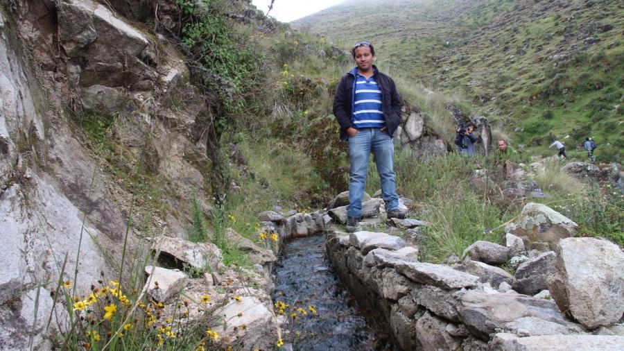 Oscar Angulo, a hydrologist for the NGO Condesan, stands by a restored stretch of canal near Huamantanga. well-manicured canal. When he first came to the town in 2012, the canals were littel more than piles of rubble, largely abandoned as young people lef