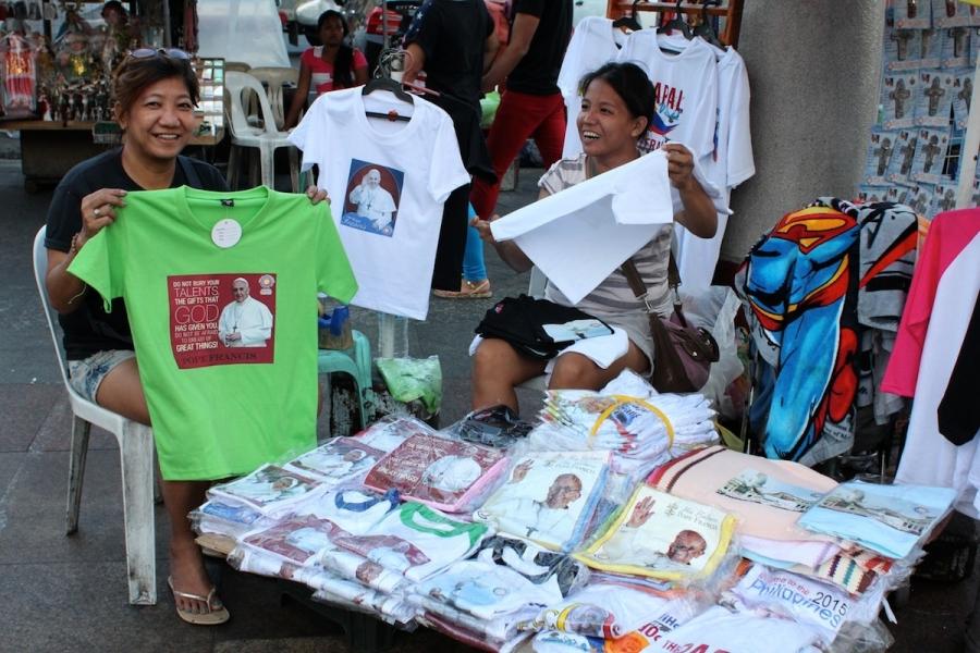 A woman shows off her Pope Francis shirts in Manila.