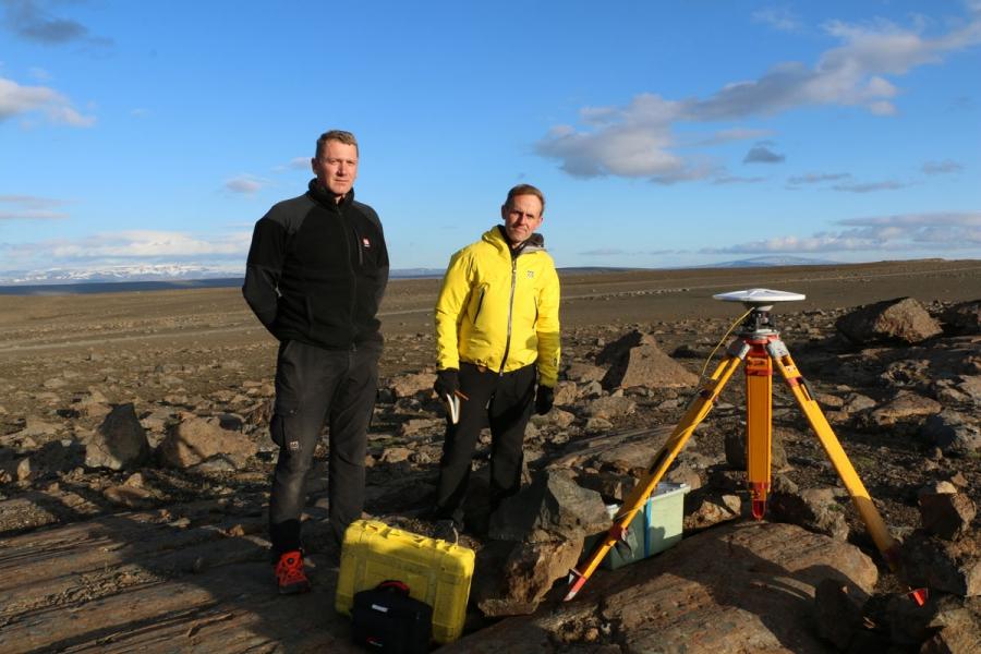 Sveinbjörn Steinþôrsson (L) and Freysteinn Sigmundsson from the University of Iceland stand beside one of their GPS stations that measures the latitude, longitude, and vertical position of the ground.