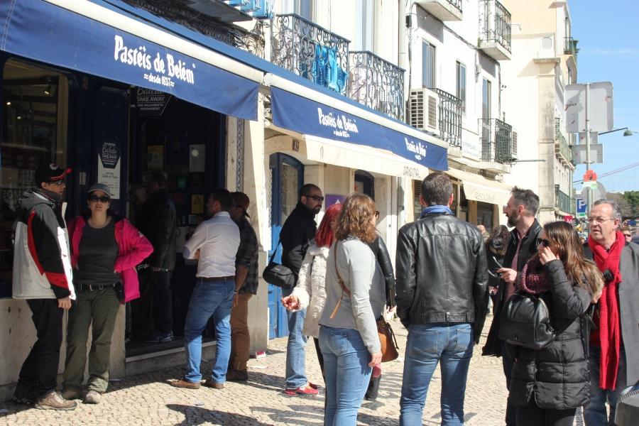 Customers line up at Pastéis de Belém. The clientele includes a growing number of tourists but is still about 60% local.