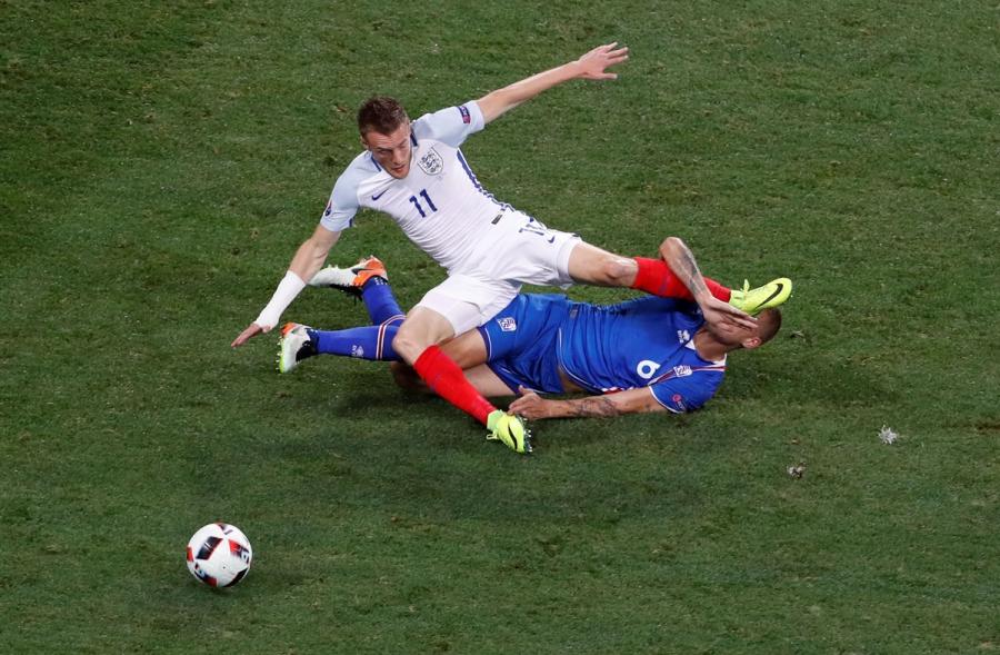 Iceland's Ragnar Sigurdsson in action with England's Jamie Vardy.
