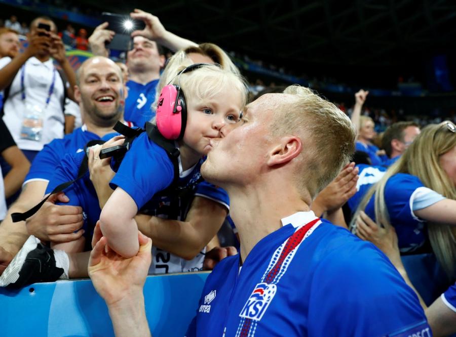 Iceland's Kolbeinn Sigthorsson and a young fan celebrate after the game.