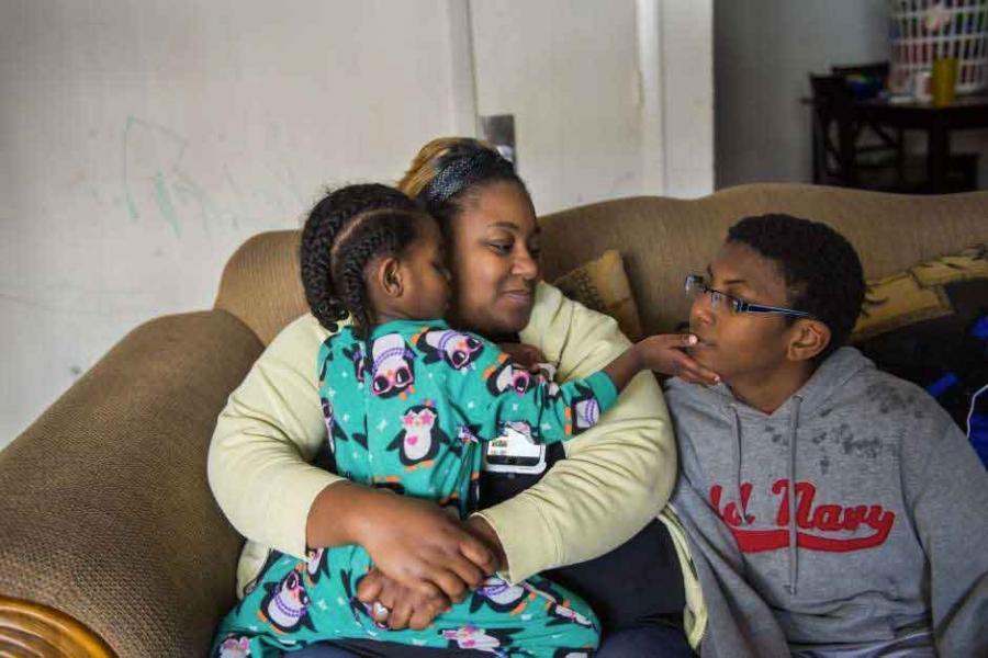 Lynchburg, Virginia resident Stacey Doss holds her toddler, B.J., while son Kayleb plays big brother. Doss, the daughter of a police officer, is outraged that a school resource officer arrested her son after he left a classroom without permission. The aut