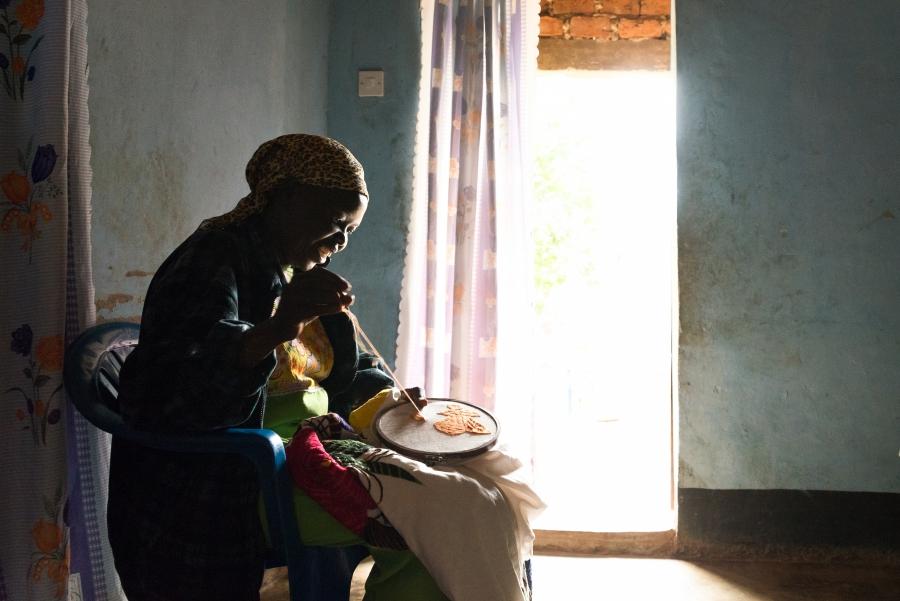 Mary embroiders a handkerchief while sharing her story of fleeing South Sudan 10 years ago.