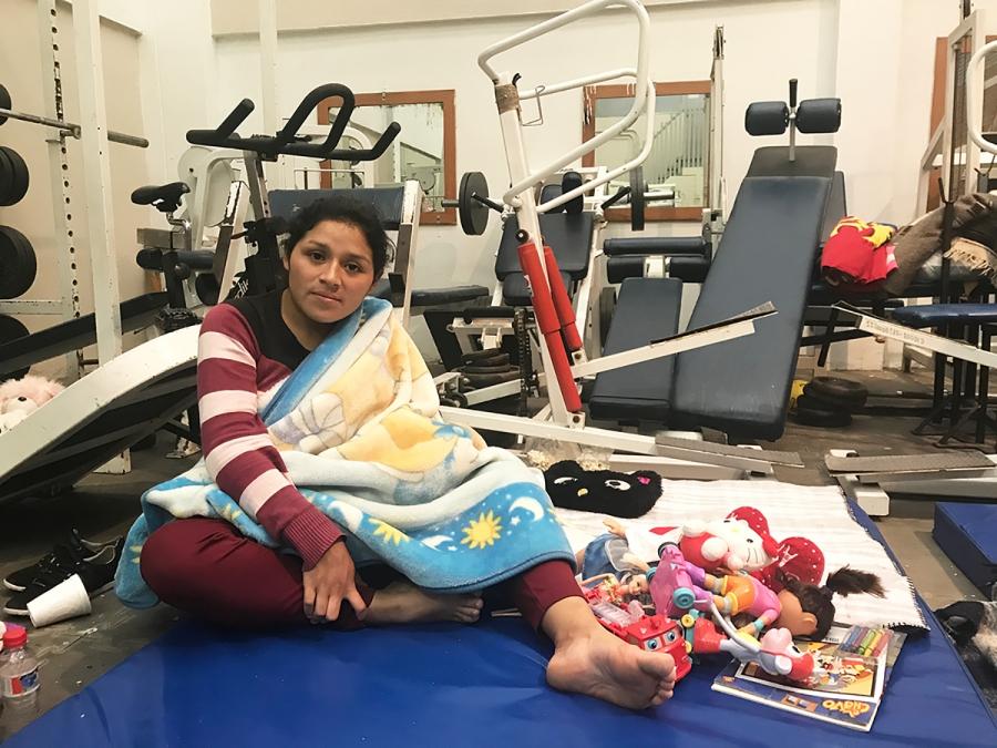 Jessica Cruz stays at a gym-turned-shelter Thursday fearing earthquake aftershocks.
