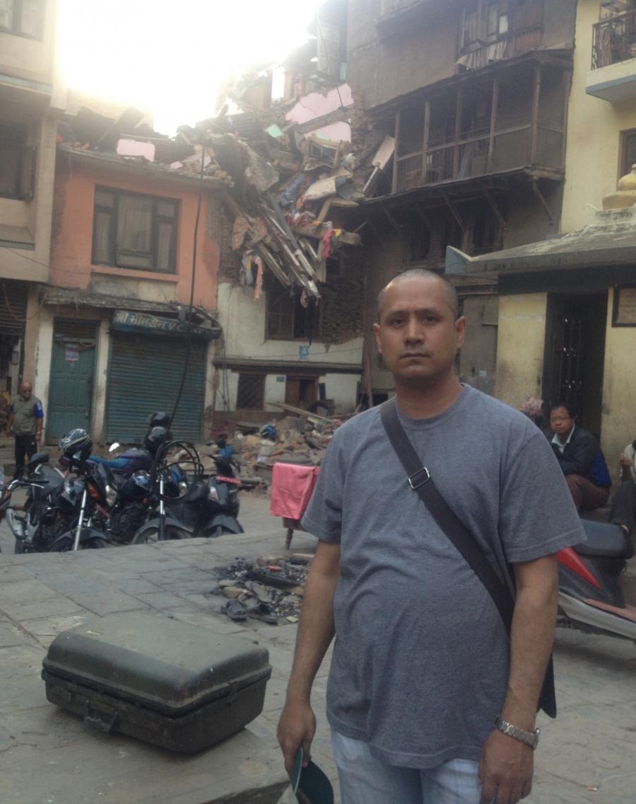 Rajesh Shrestha stands in front of his home in Nepal in March of this year. 