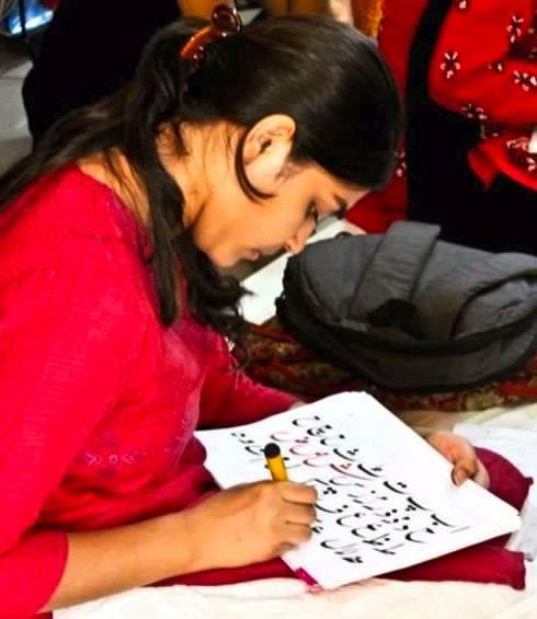 Nusrat Ansari practices her Urdu writing skills.