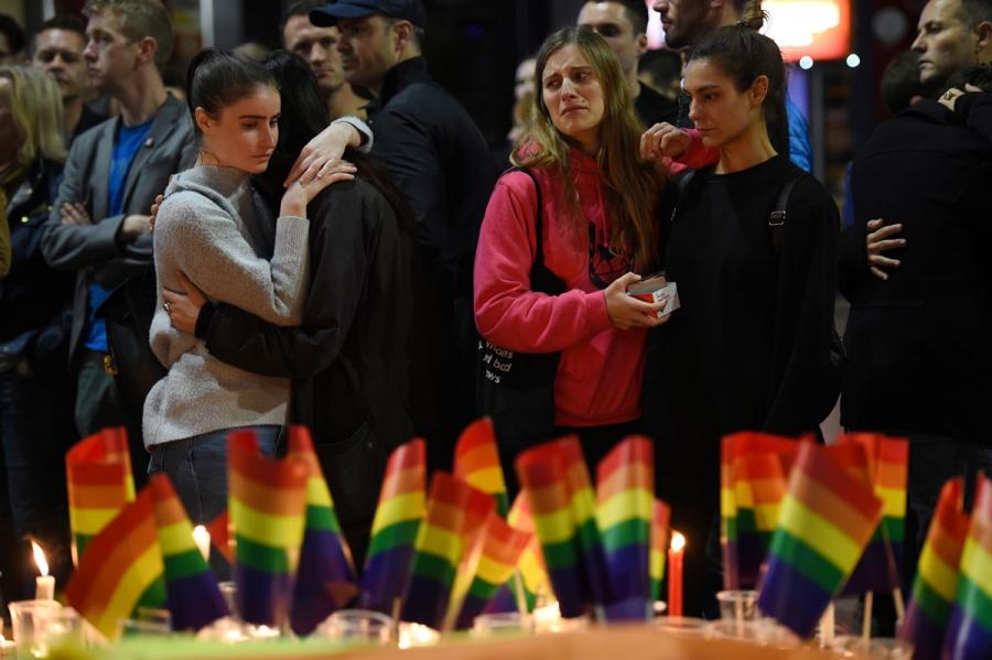 People gather at a vigil in solidarity for the victims of the Orlando nightclub mass shooting at Taylor Square in Sydney, Australia.