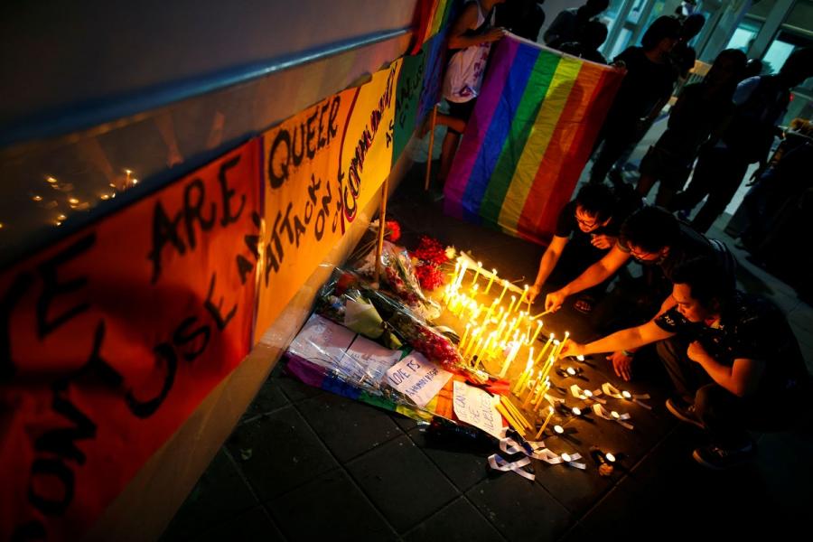 People attend a candlelight vigil in solidarity for the victims of the mass shooting in Orlando, at the US Embassy, in Bangkok, Thailand.