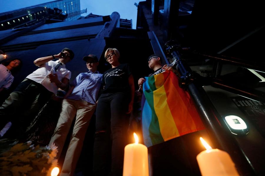 Hong Kong singers Anthony Wong (3rd R) and Denise Ho (2nd R) take part in a candlelight vigil in Hong Kong.