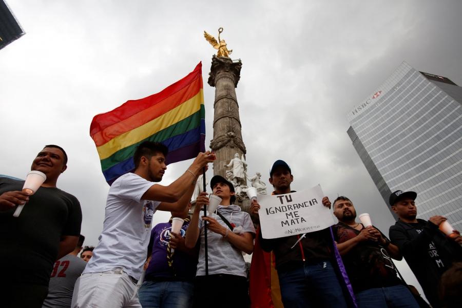 Members of the LGBT community take part in a vigil for the Orlando victims at the Angel of Independence monument in Mexico City, Mexico.