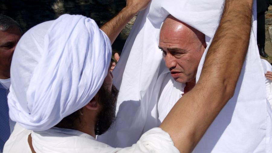 Wisam Breegi (right) prepares to be baptized by a visiting Mandaean high priest. Breegi is hoping to raise funds to build a Mandaean temple in the Worcester area.   