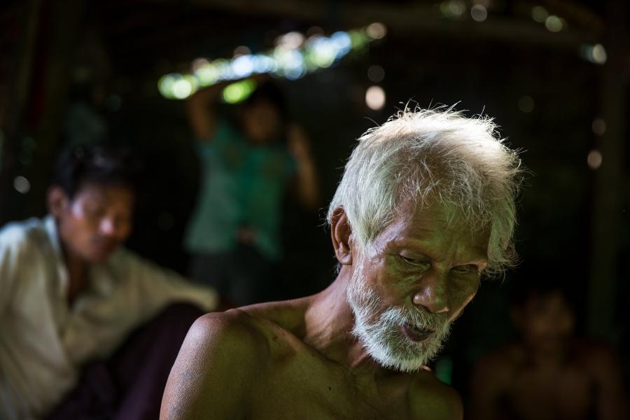 U Hla Myint, 65, sits in his home at a small village where migrant workers for Supowin Palm Oil live outside Kawthaung, Myanmar, Nov.14, 2016. Myint and his wife retired five years ago. They're now supported by two sons.  