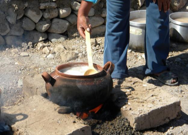 hicha is cooked over a llama-dung fire. When the water boils, a thick mixture of water and ground corn is added to the brewing vessel. Photo courtesy of the Cerro Baul Archaeological Project