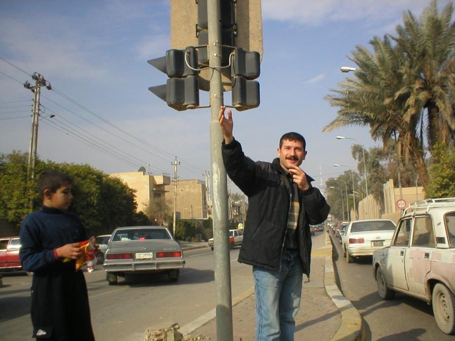 Ayub, fed up with congestion at an especially busy Baghdad intersection, jumped out of the car to direct traffic.