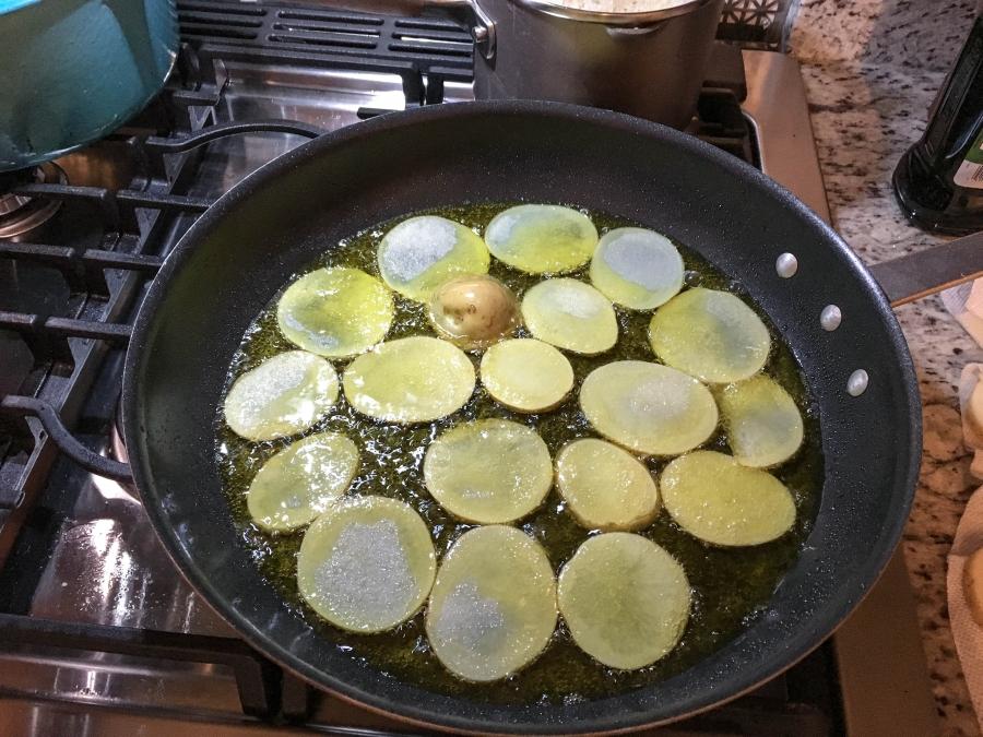 Potatoes fry in a pan at Amanda Saab's kitchen.