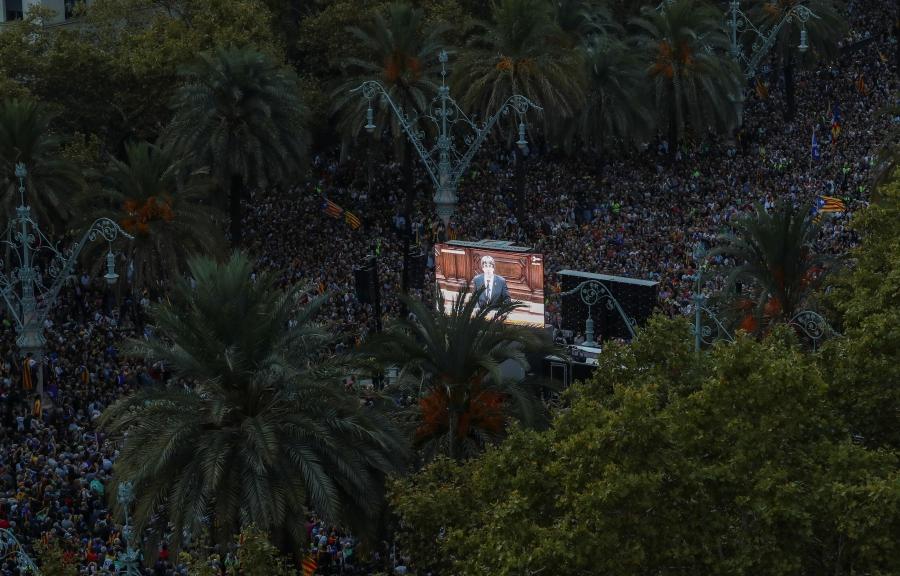 People watch Catalan President Carles Puigdemont address the regional parliament while they attend a pro-indpendence rally near the Catalan regional parliament in Barcelona, October 10, 2017.