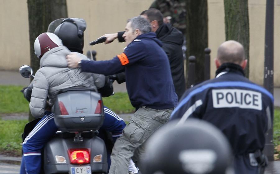 French police forcibly stop at gun point young people on a scooter as they arrive near the scene of hostage-taking at a kosher supermarket near Porte de Vincennes in eastern Paris on Jan. 9, 2015.