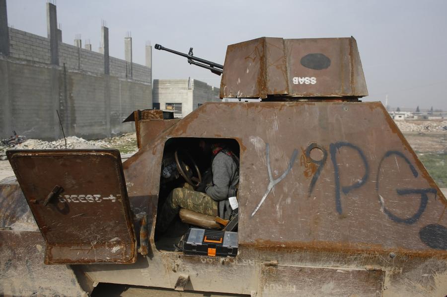 A fighter of the Kurdish People's Protection Units, or YPG, sits in an armored vehicle in the northern Syrian town of Kobane on January 28, 2015.