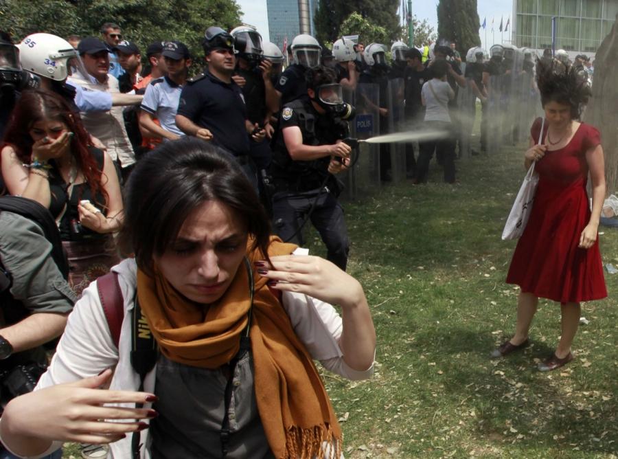 A Turkish riot policeman sprays tear gas in what became an iconic image during the Gezi Park protests on May 28, 2013.