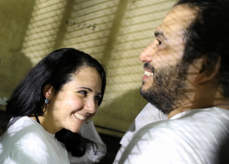 Aya Hijazi and her husband, Mohamed Hassanein, talk inside a holding cell.