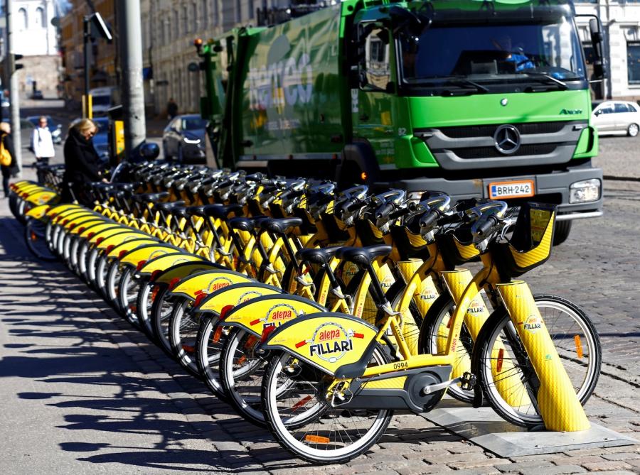 A vehicle passes near a dock for Helsinki's bike-sharing system, on May 3, 2017.