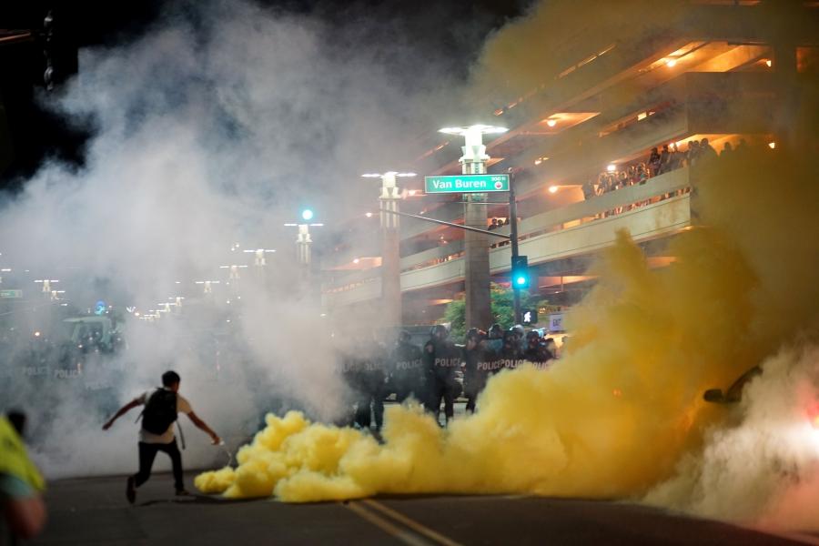 Police officials lob tear gas after President Donald Trump's campaign rally in Phoenix, Arizona, Aug. 22, 2017.