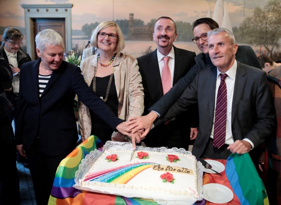 Germany's first married same-sex couple Karl Kreil and Bodo Mende cut a wedding cake after getting married.