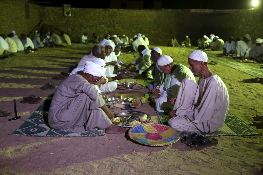 Invitees eat dinner as people celebrate a traditional Nubian wedding in the Nubian village of Adindan on Sept. 30, 2015.