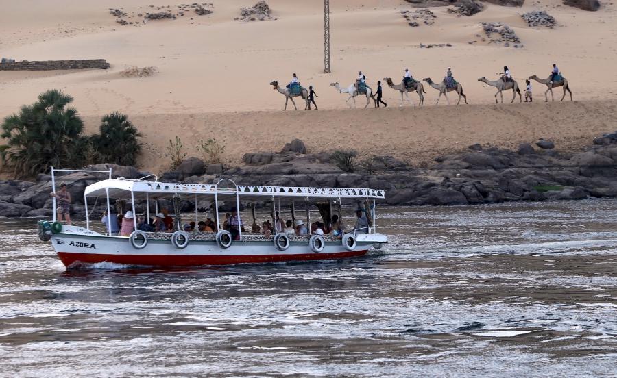 Tourists ride in a falluka (small boat) along the Nile river in Aswan on the way to Nubia, in southern Egypt.