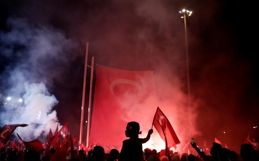A young boy waves a Turkish national flag as supporters of Turkish President Tayyip Erdogan gather during a pro-government demonstration on Taksim square in Istanbul, Turkey, July 18, 2016.