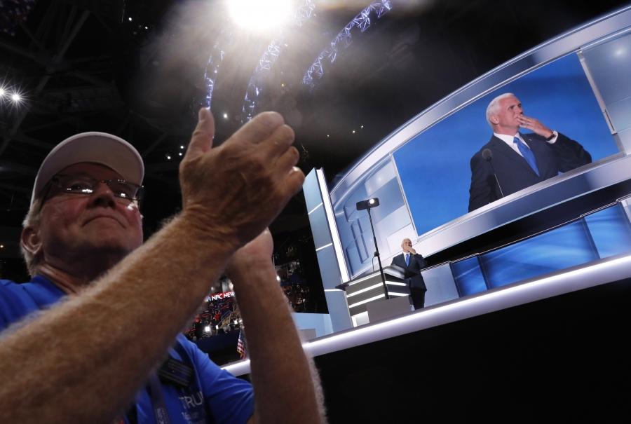 A delegate applauds as Republican vice presidential nominee Indiana Governor Mike Pence speaks during the third night at the Republican National Convention in Cleveland, Ohio, U.S. July 20, 2016. 