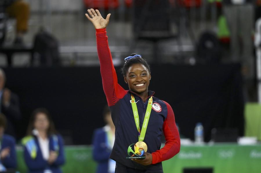 Simone Biles of the U.S. poses with her gold medal.