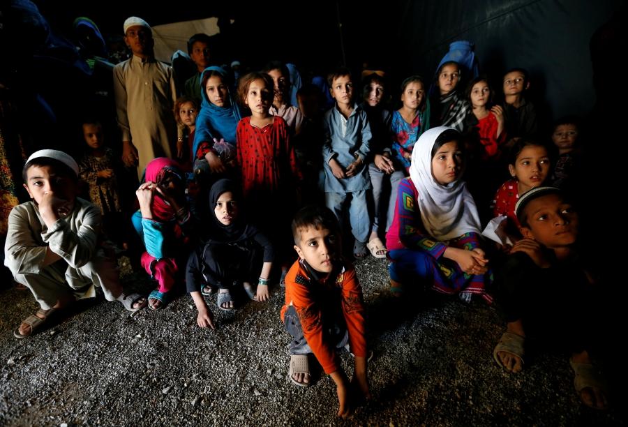 Afghan refugee children, returning from Pakistan, watch a short video about mine safety and explosives awareness at a UNHCR registration center in Kabul, Afghanistan, Sept. 27, 2016.
