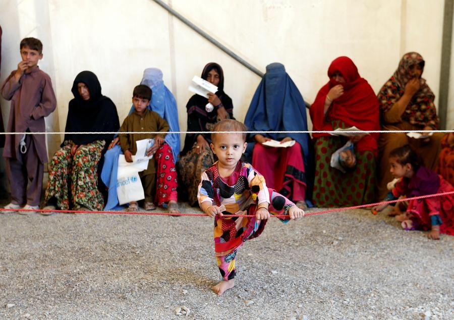 Afghan women sit with their children after arriving at a UNHCR registration center in Kabul, Afghanistan, Sept. 27, 2016.