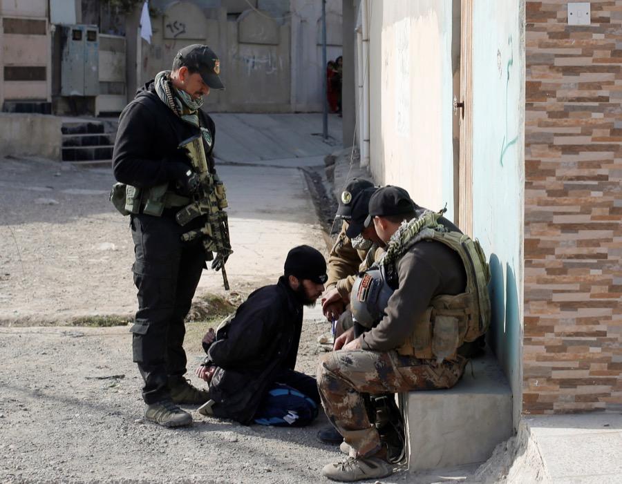 Iraqi special forces intelligence officers talk to a suspected ISIS fighter in Mosul, Iraq on Nov. 27.