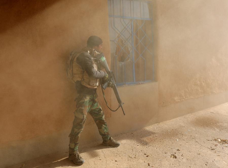 An Iraqi soldier searches a house during clashes with ISIS fighters in a town southeast of Mosul, Iraq on Nov. 28.
