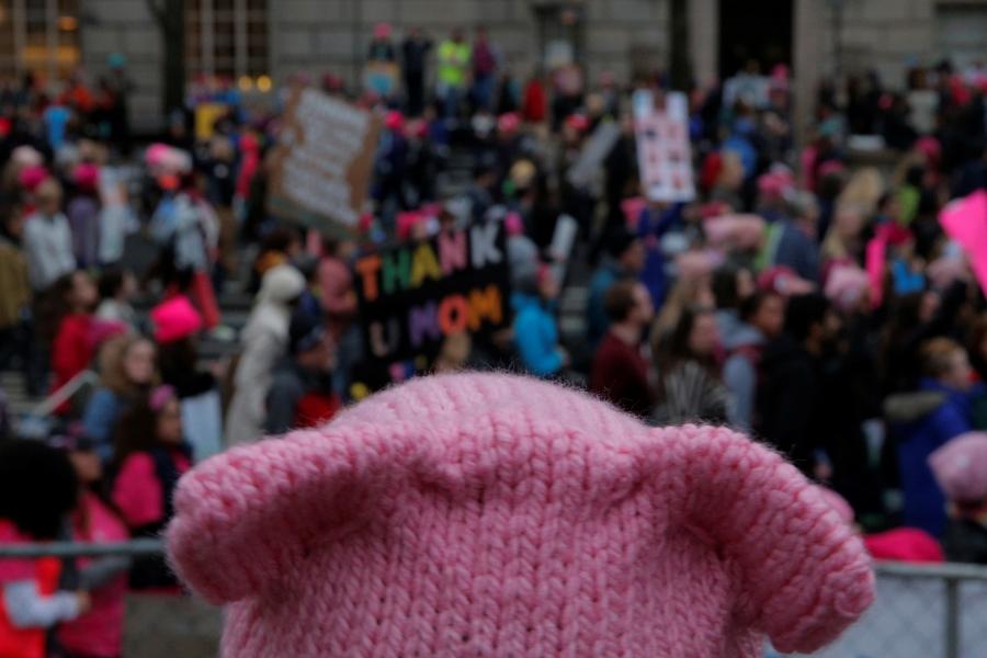 A woman wearing pink pussy protest hat watches the Women's March on Washington, following the inauguration of US President Donald Trump, in Washington, DC, January 21, 2017.