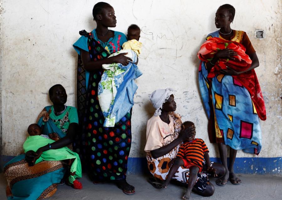 Women hold their babies as they wait for a medical check-up at a UNICEF-supported mobile health clinic in Nimini village, Unity State, South Sudan