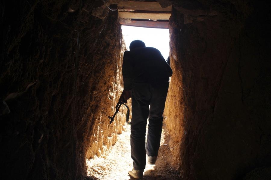 A Free Syrian Army fighter walks through a tunnel on the frontline of Eastern Ghouta, Syria, Feb. 1, 2014.