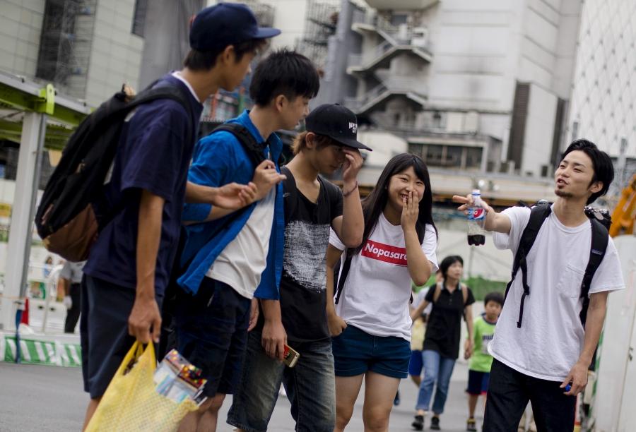 Aki Okuda (R), founding member of the Japanese protest group Students Emergency Action for Liberal Democracy (SEALDs), talks to supporters in central Tokyo, August 24, 2015.